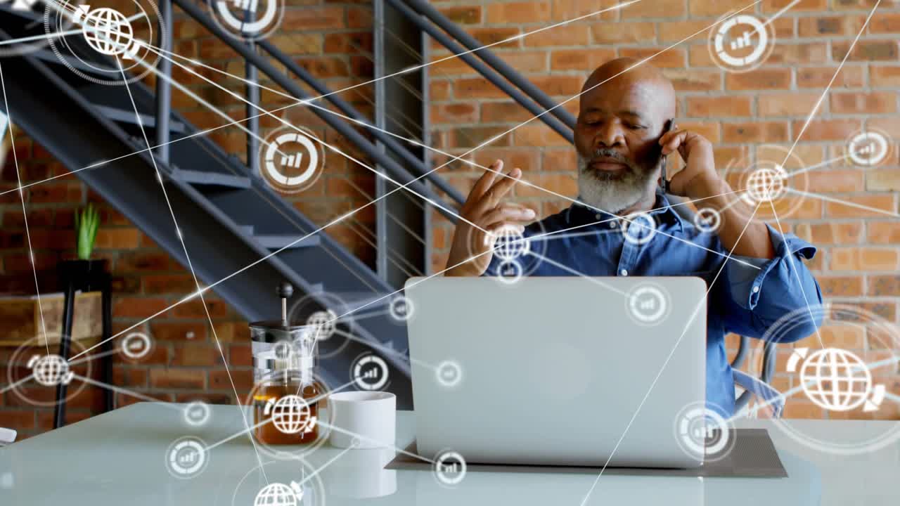 Vertical video: Mature man using phone and gesturing at laptop starting nodes showing data flow