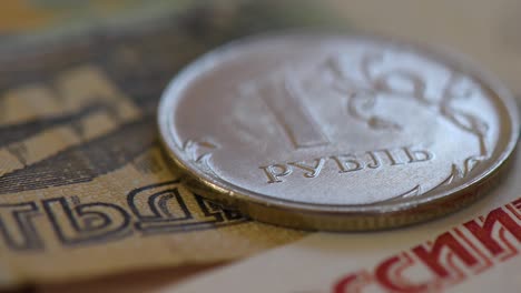 cash from the russian federation: detail of banknotes and 1 ruble coin. closeup shot in slow rotation