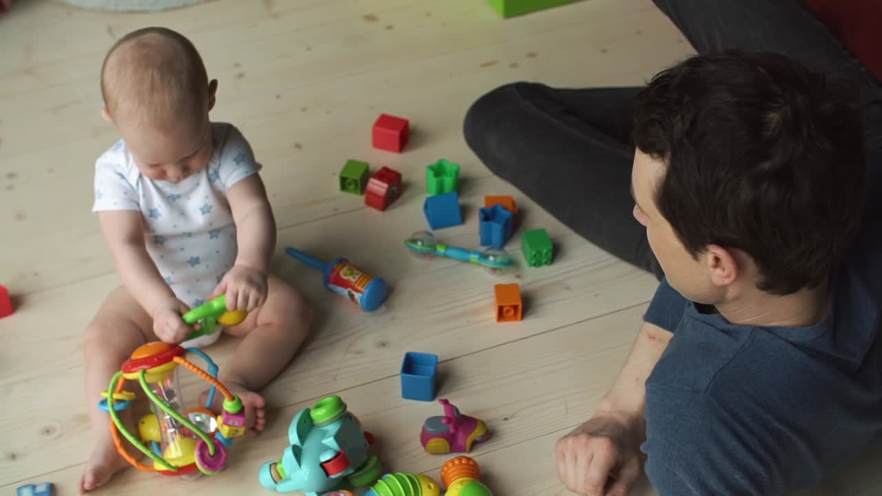 Baby playing with toys with parent