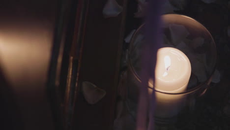 close-up of wedding candle with flower petals