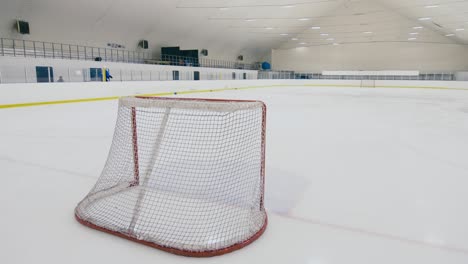 first hockey player going out on empty ice arena