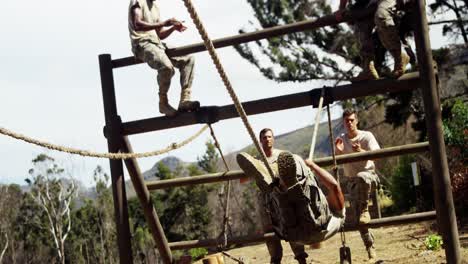 military soldier crossing the rope during obstacle course 4k