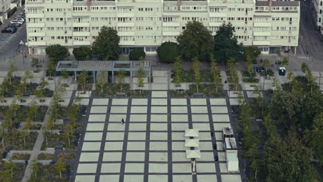 aerial view of a city square with modern buildings and park