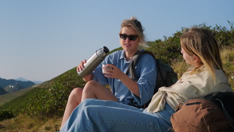 friends enjoying a drink on a hike