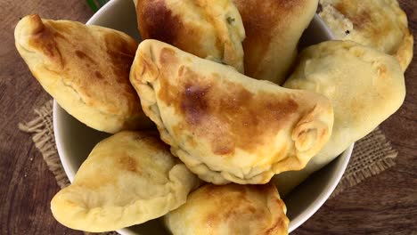 homemade empanadas on a rotating plate (seamless loopable)