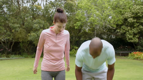 diverse multiracial couple enjoying walk in park, smiling and talking together