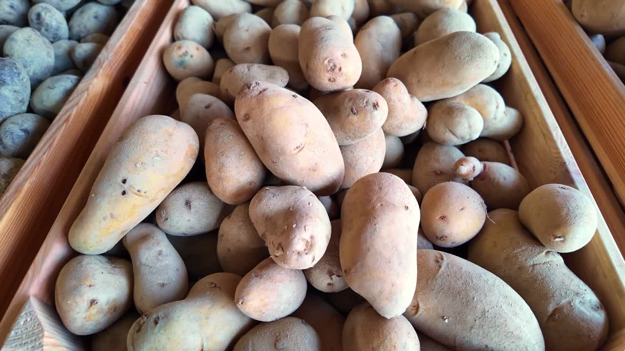 Close-up of fresh organic potatoes in wooden crate