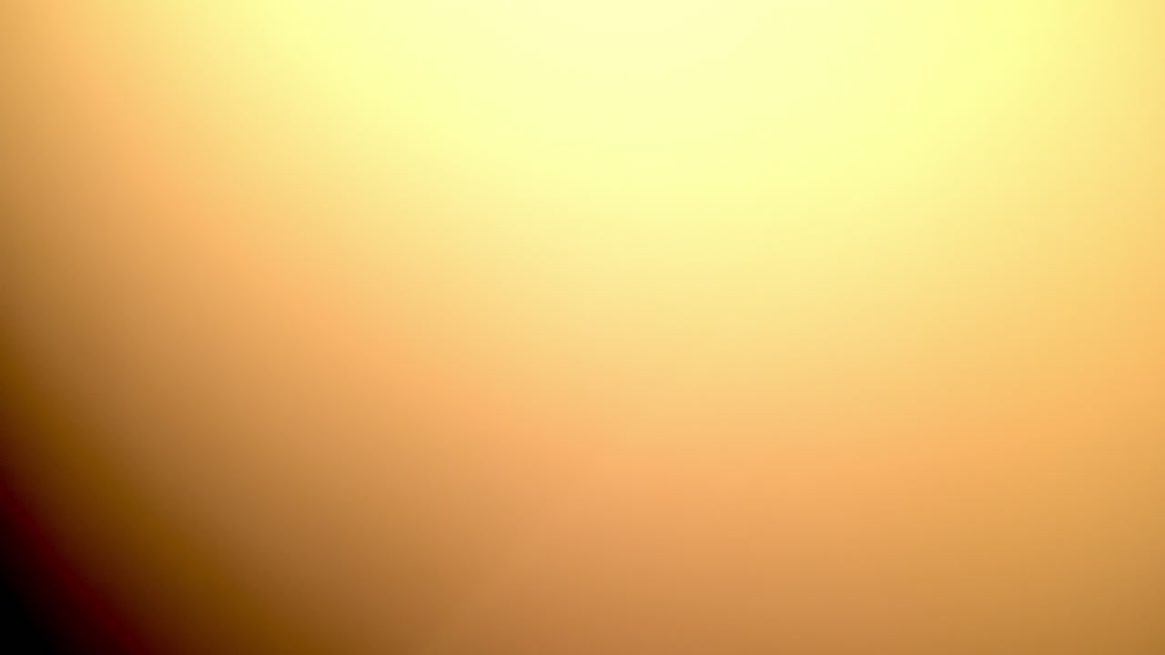 Blurred warm light transition effect over black background