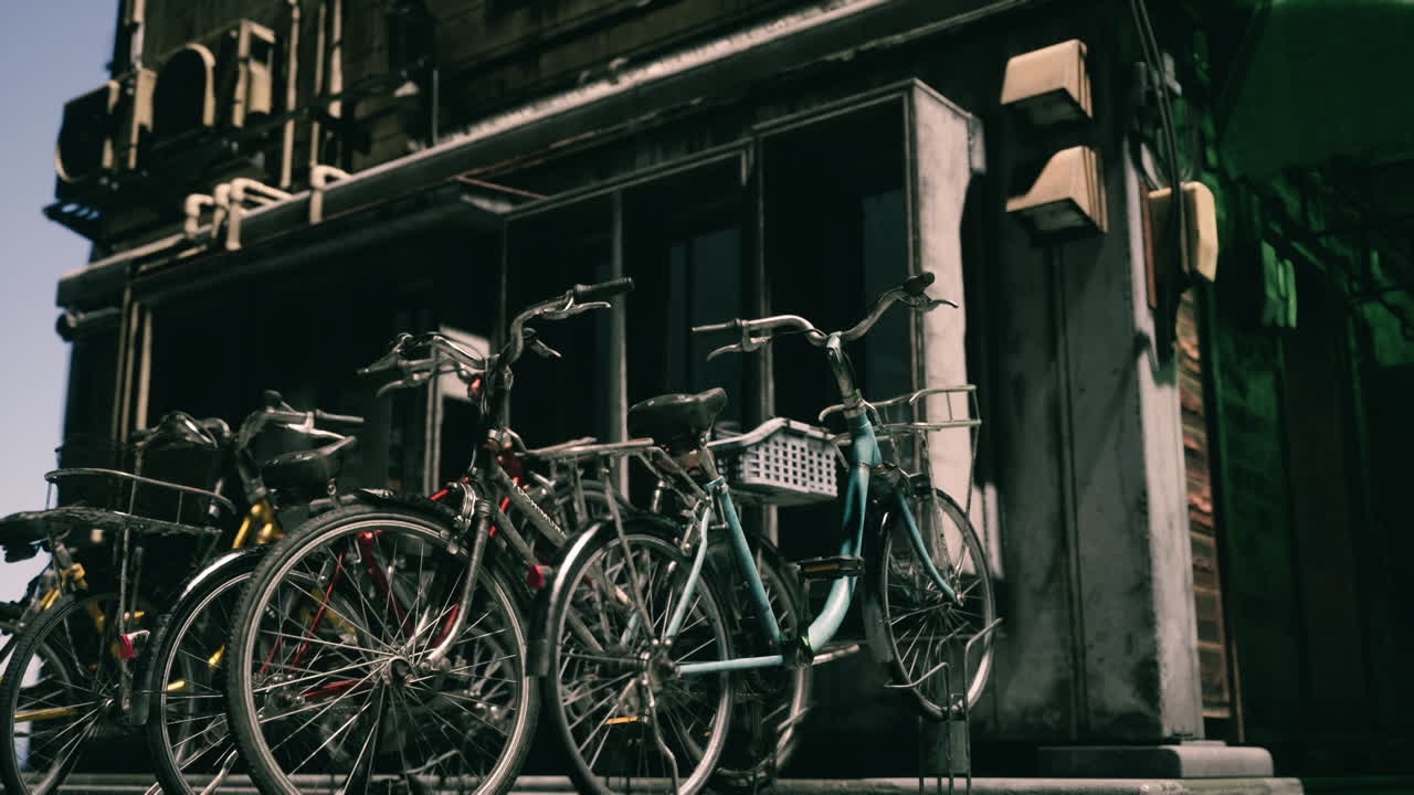 Bicycles parked near a building during a sunny day in a vibrant city street