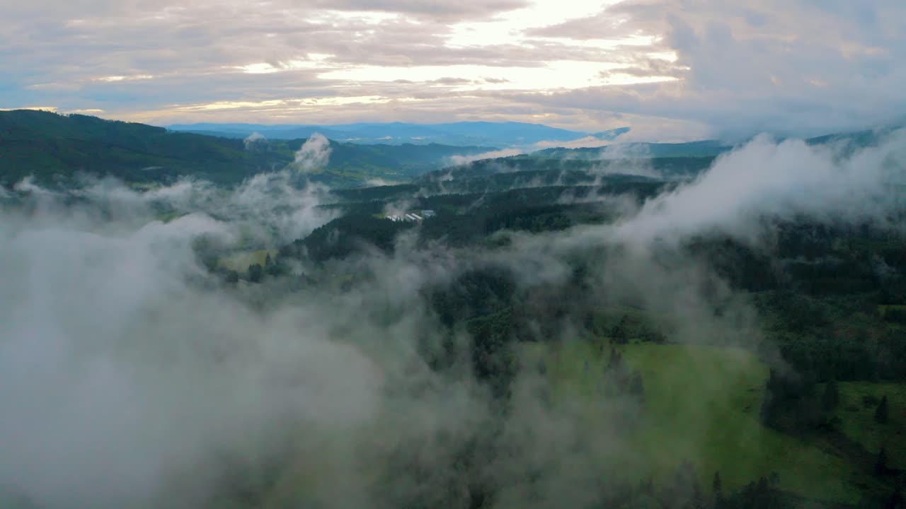Aerial drone Over misty rural mountains in Countryside With Low moving Clouds In The Morning fog. Tatra mountain range in Slovakia, Stratus Silvagenitus forest evaporation clouds