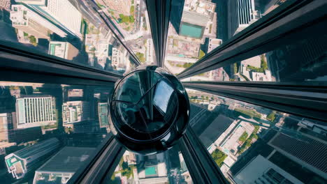 high-rise cityscape from a glass elevator