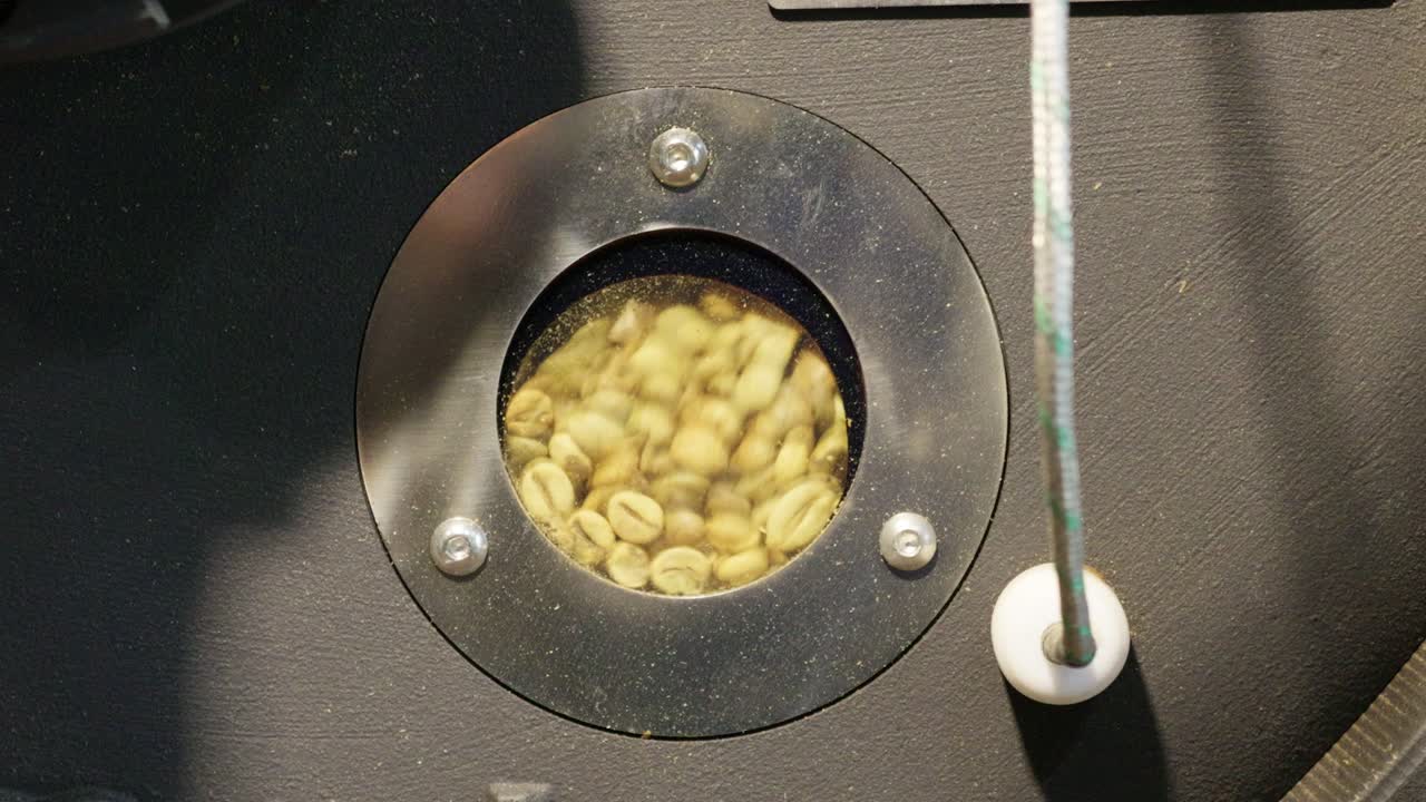 Watch as coffee beans roast showcasing the meticulous process of creating the perfect brew.