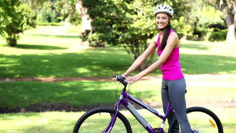 fit girl going for a bike ride in the park