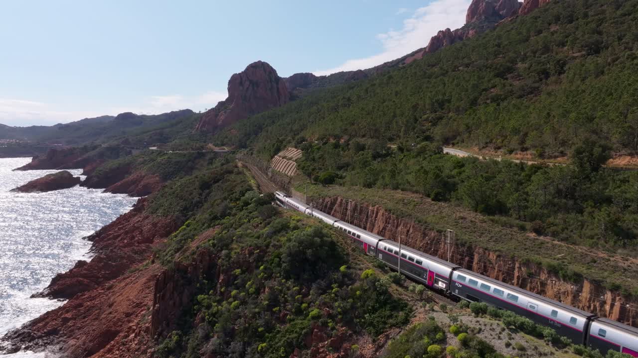Aerial view of train winding through Massif de L'Esterel by sea, France