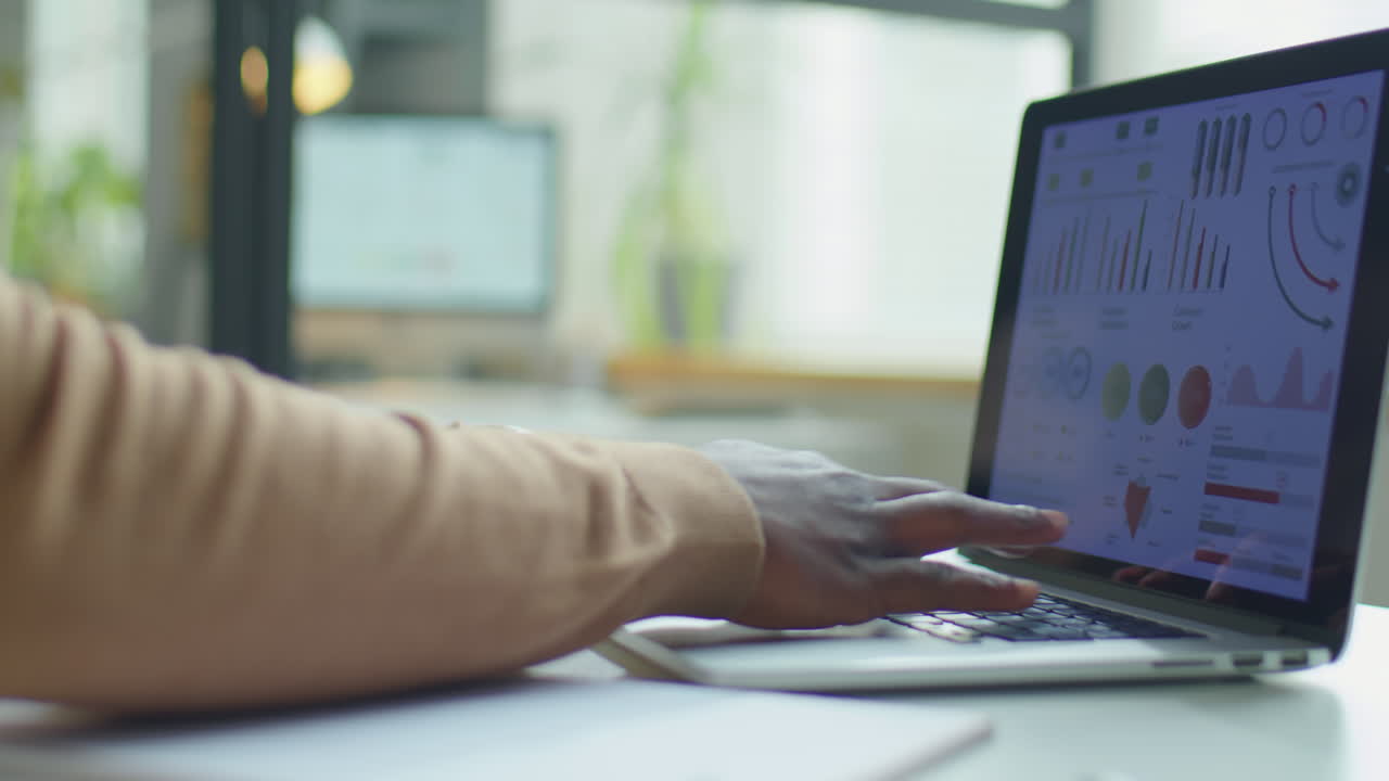 Businessman Working with Financial Data on Laptop