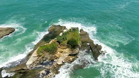 Eroded-rock-washed-by-ocean-waves-on-Klayar-beach,-East-Java,-Indonesia,-aerial