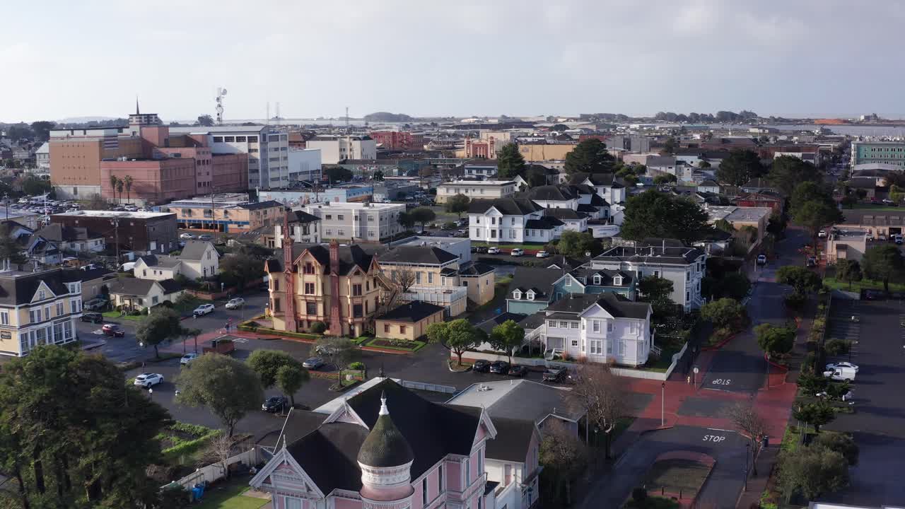 Aerial low shot flying over historic Victorian mansions in old town Eureka, California. 4K