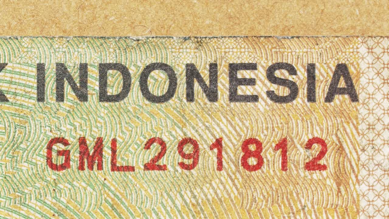 Macro pan over Bank Indonesia text on an Indonesian rupiah note