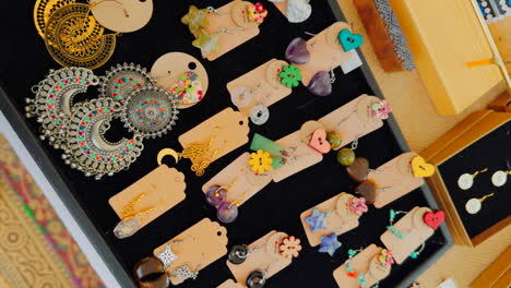 handmade earrings of different types on a flea market counter