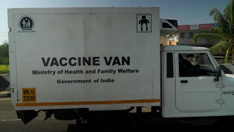 Side-angle-of-Mahindra-Bolero-Vaccine-van-on-road-in-Maharashtra,-India