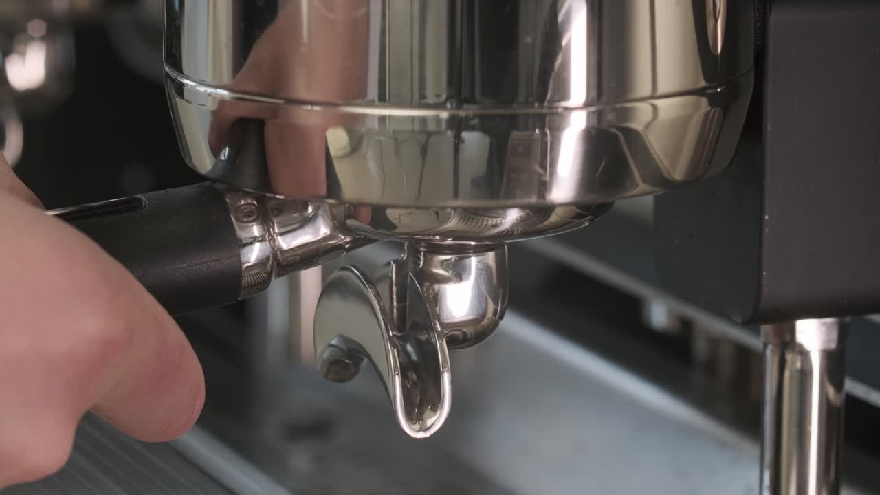Close up of coffee powder being pressed and prepared for brewing a fresh cup of espresso