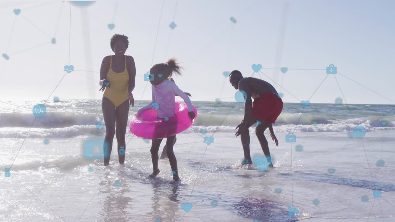 Family wading surf, kids in pink or yellow rings jumping, parents reacting, blue icon overlay for ad