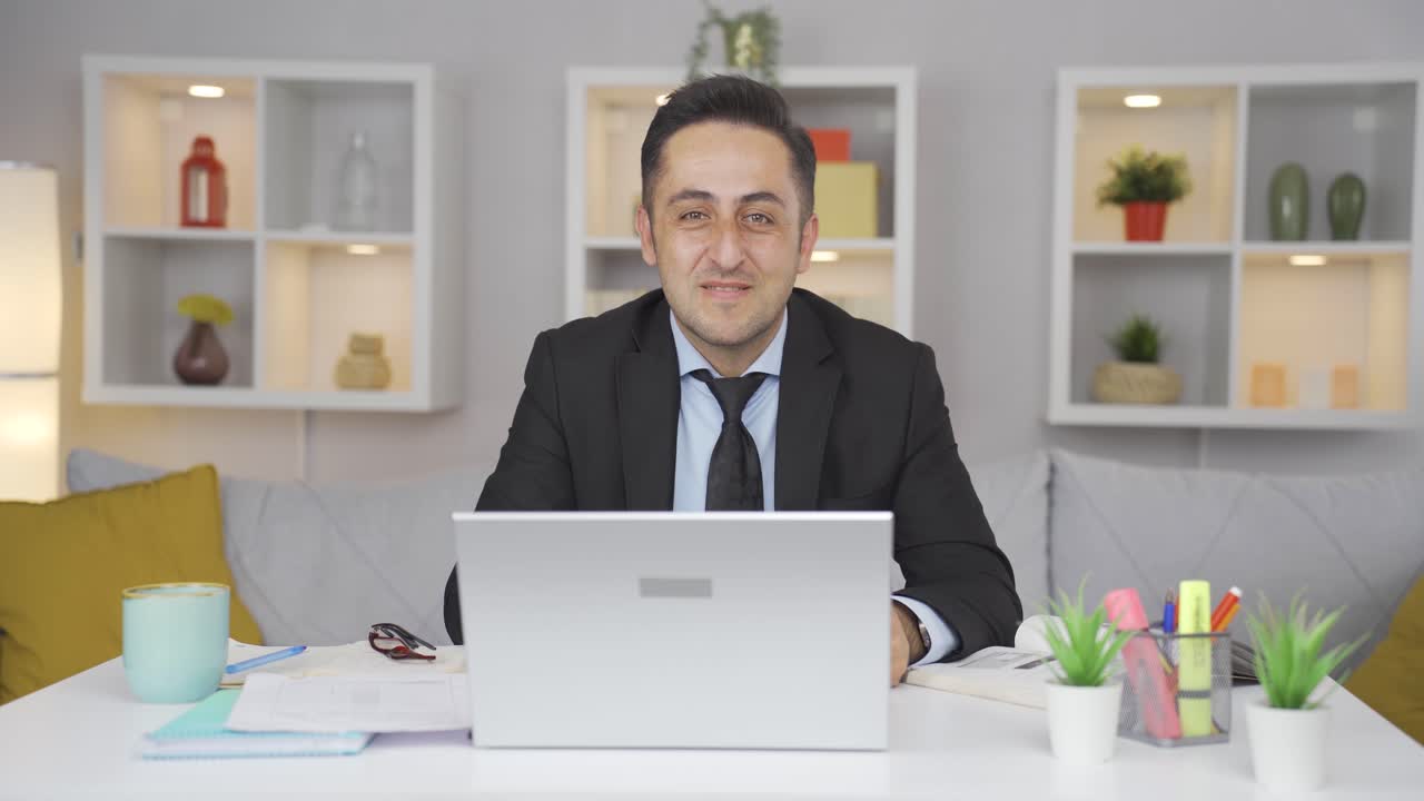 Home office worker man making positive gesture at camera.