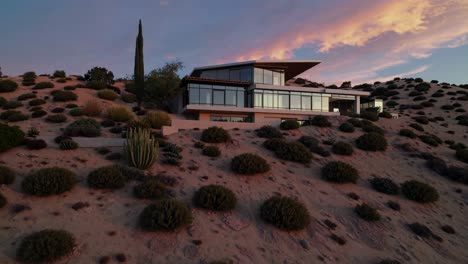 modern house on a hillside at sunset