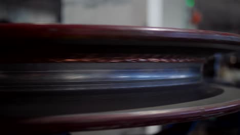 manufacture of electric cable. close-up of a copper wire drawn by the method of drawing in the factory equipment.