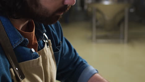 man taking malt from sack