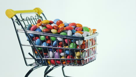 Sweets-In-A-Shopping-Trolley-On-A-Black-Background-4k-Video