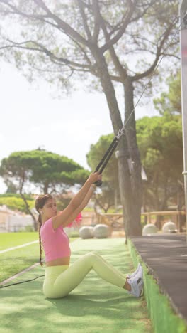 woman performing seated cable rows at an outdoor gym