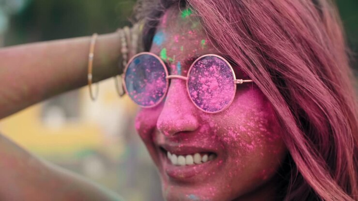 Close up of Asian woman's face in holi colors
