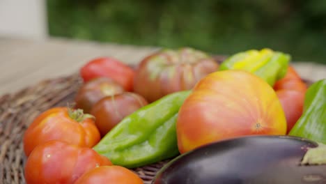 Hand-held-shot-of-a-hand-selecting-fresh-organic-vegetables-from-a-wooden-basket