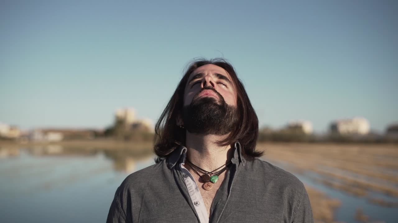 Man in a contemplative pose outdoors