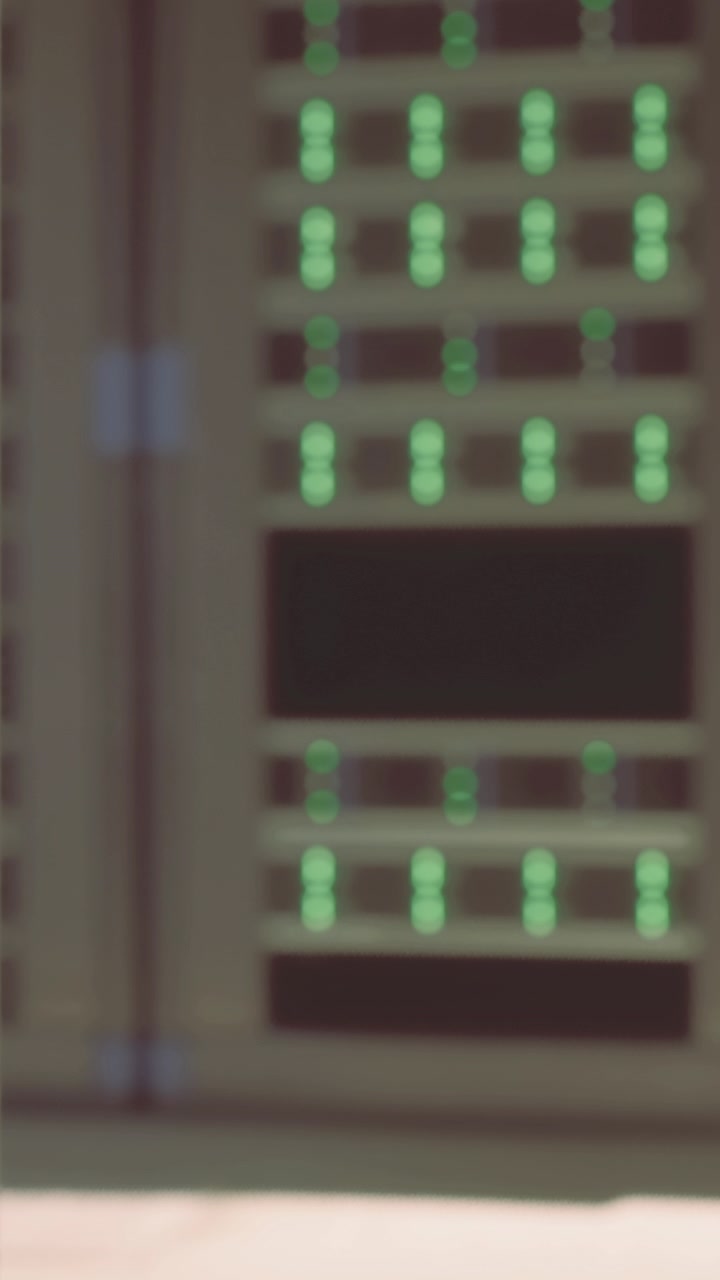 Network server room with multiple lights on panels showing active processes