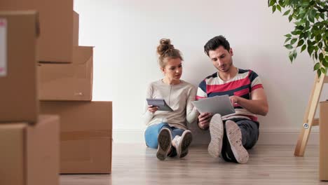 worried couple examining expenses after moving into new house