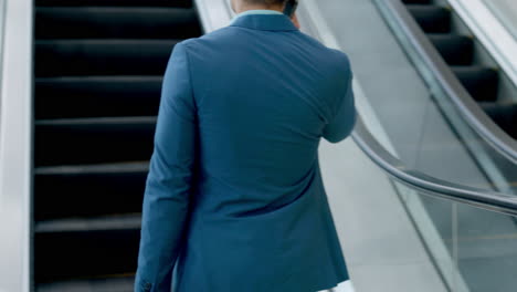 Businessman,-walking-and-escalator-in-office-lobby