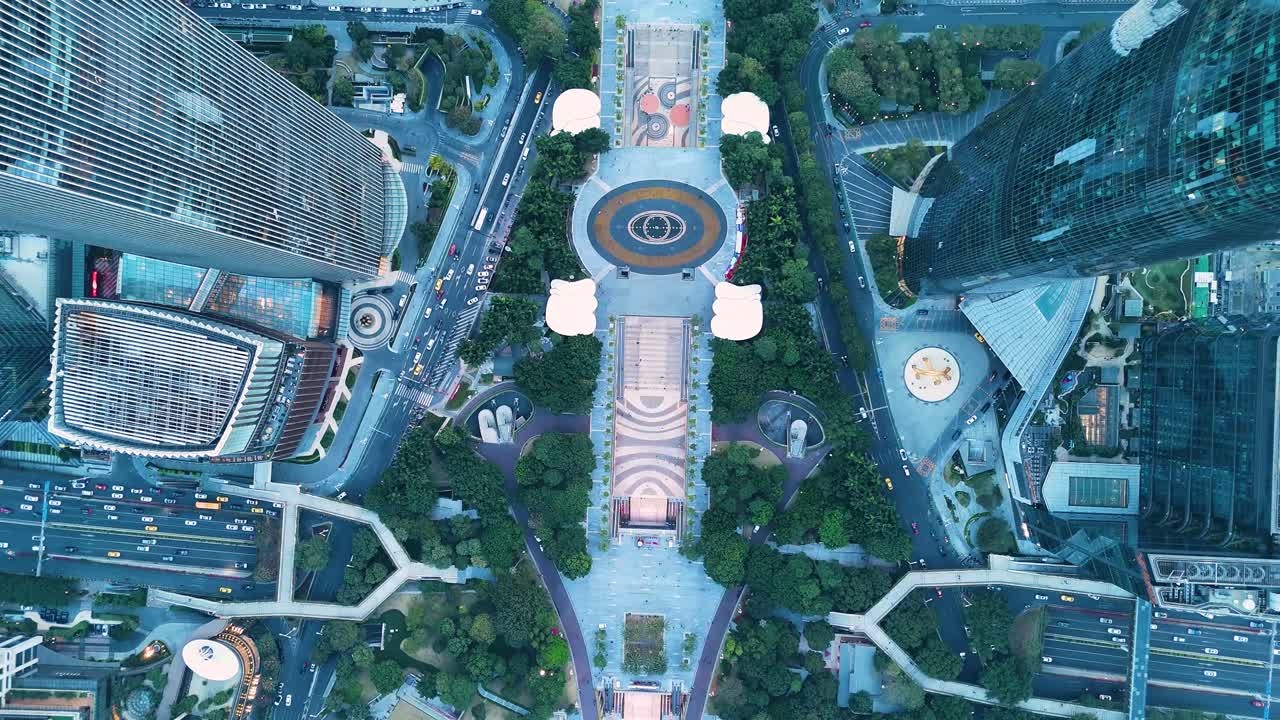 Aerial top-down view of Huacheng Square in Guangzhou, China, showcasing modern skyscrapers, urban roads, and green spaces in the heart of the city. Dynamic urban development.