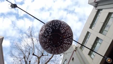 looking up at lamp lantern hanging outdoor - low angle view