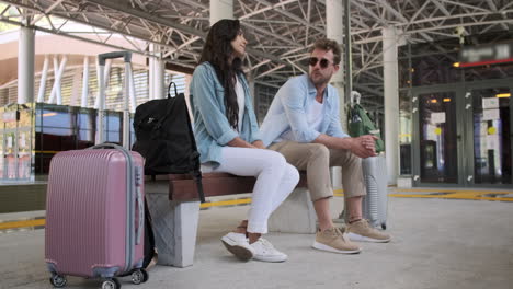 couple waiting at a train station/bus station