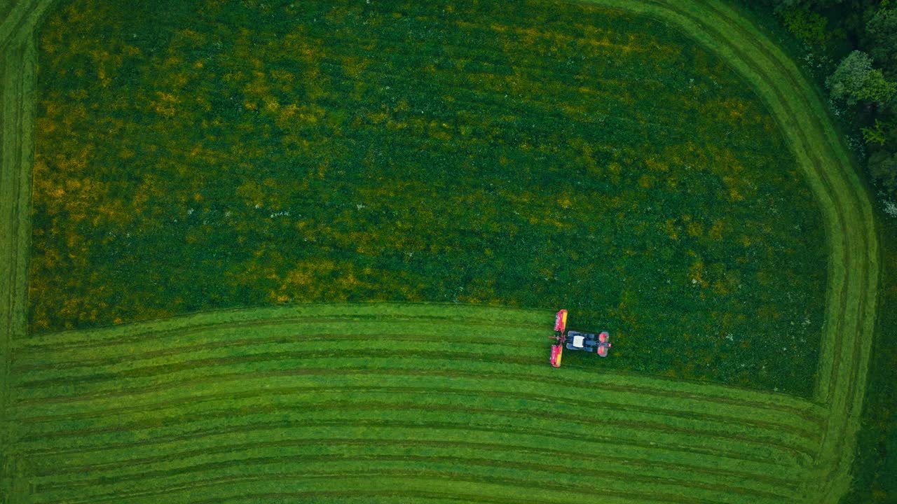 Top Down View Of Agricultural Mower Working On The Farm - Drone Shot