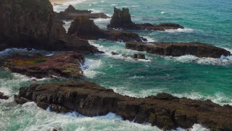 outcrops with crashing waves at cathedral rocks near coastal town of jones beach in kiama, nsw australia