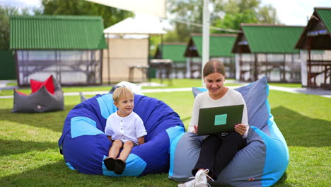 mother and son relaxing and working outdoors