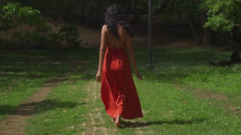 a young latina girl wearing a dress delights in the beauty of a park on the caribbean island of trinidad