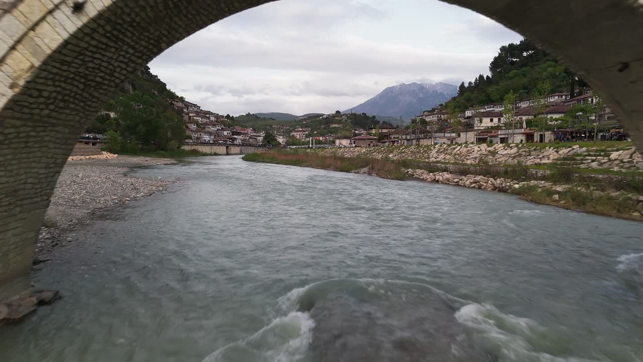 Historic stone bridge over river in Berat, Albania, showing tranquility