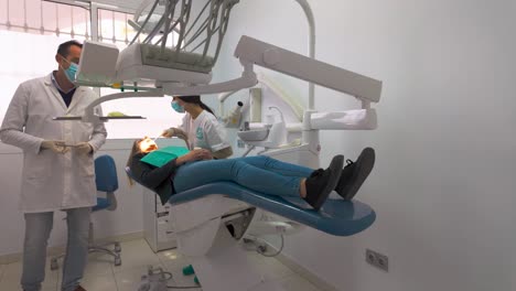 woman removing tooth at the dentist