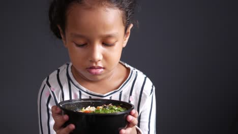 girl eating soup