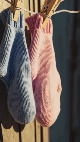 two pairs of socks drying on a clothesline