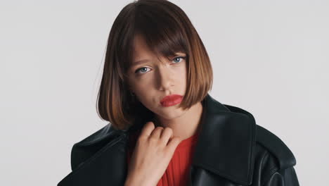 unhappy young woman in black jacket posing